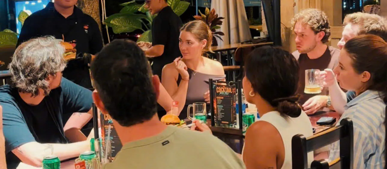 Guests enjoying burgers and beer at P Burger in the evening